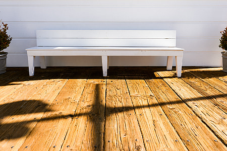 white wooden bench near white wall thumbnail