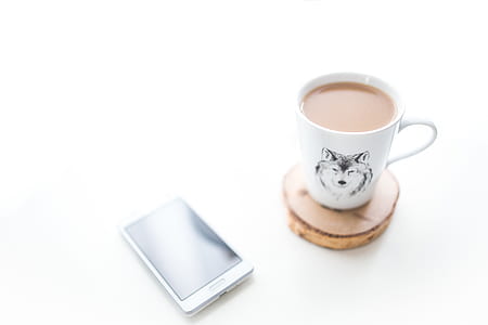 White desk with a cup of coffee and mobile phone thumbnail