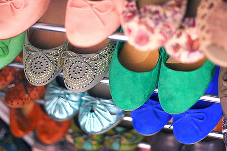assorted pairs of footwears on stainless steel rack thumbnail