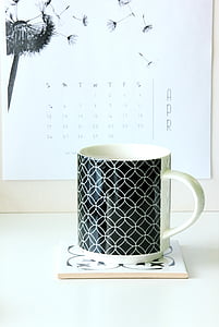 white and black ceramic mug on white coaster thumbnail