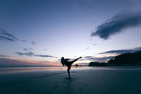 silhouette of person standing on seashore thumbnail