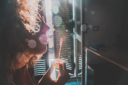 bokeh photography of woman doing blow bubbles thumbnail