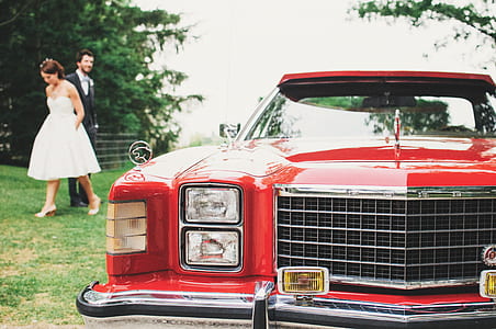 Couple Standing Near Red Classic Monte Carlo thumbnail