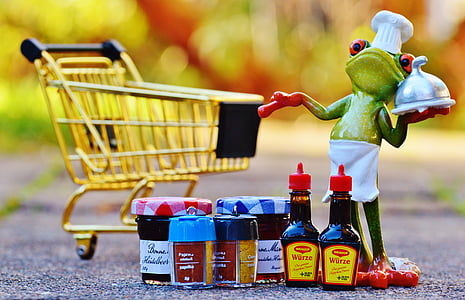 selective focus photography of frog figurine with shopping cart thumbnail