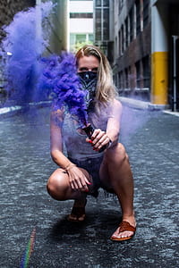 woman holding purple color smoke grenade thumbnail