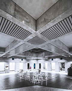 metal chairs and tables inside concrete building thumbnail