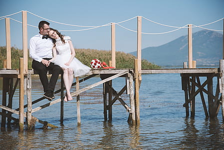 Photo of Couple Sitting On Dock thumbnail