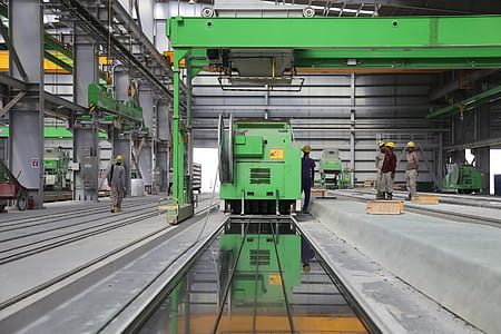 People Stands Near Green Metal Industrial Machine thumbnail