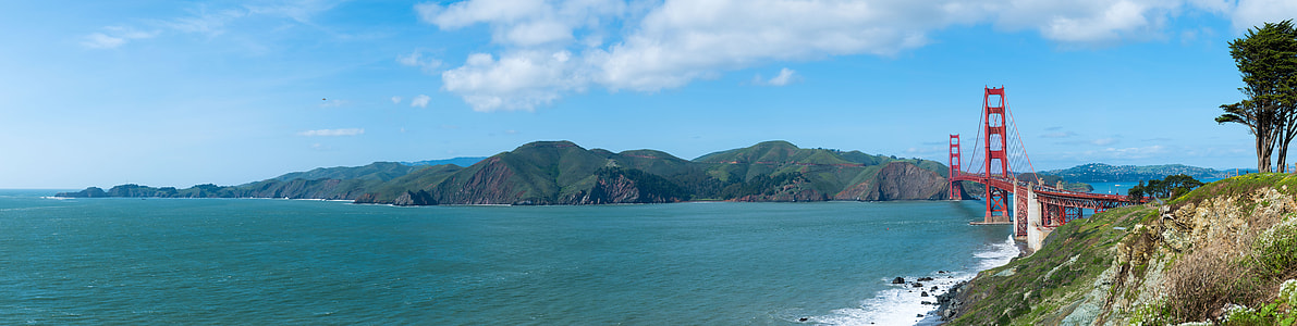 aerial view photography of sea and red bridge during daytime thumbnail