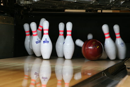red bowling ball beside pins thumbnail