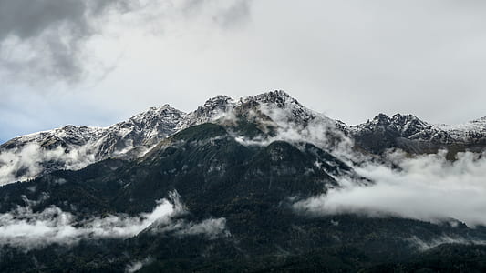 smoke covered mountain under white cloudy sky thumbnail