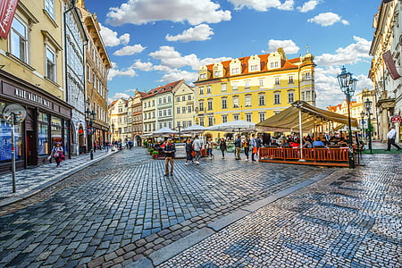 people at plaza surrounded with buildings thumbnail