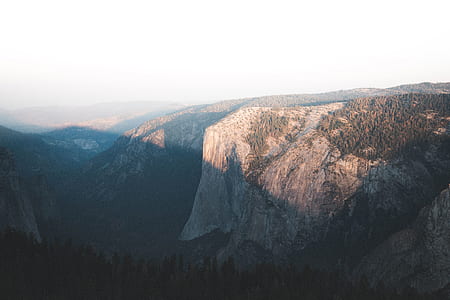 aerial photography of cliff under white clouds thumbnail