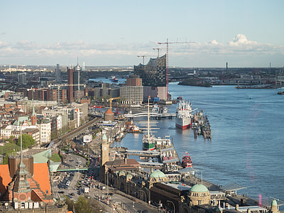 ship and boats near seashore and buildings thumbnail