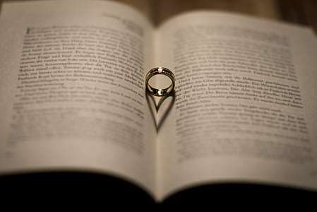 silver-colored ring on whit opened book thumbnail