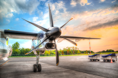 photo of gray airplane under cloudy sky thumbnail