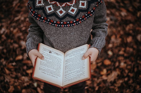 person holding opened book thumbnail