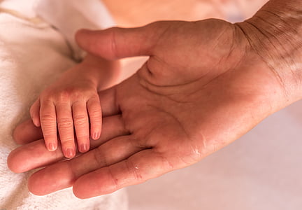 person holding baby's left hand thumbnail