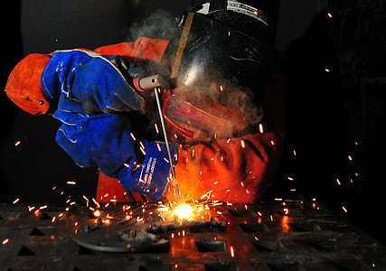 man wearing welding helmet holding welding torch thumbnail