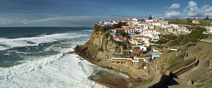 aerial photo of houses on top on mountains surrounded by body of water thumbnail