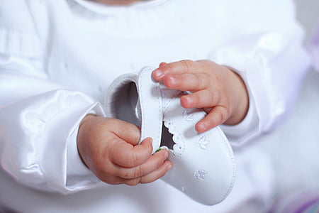 photo of baby holding white shoe thumbnail
