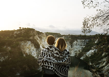 man and woman facing mountain during daytime thumbnail