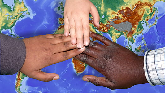 hands of three people on top of map thumbnail