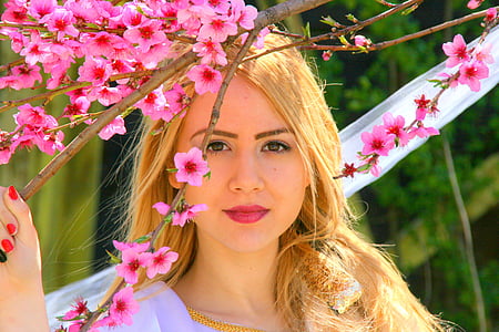 woman holding cherry blossom tree branch thumbnail