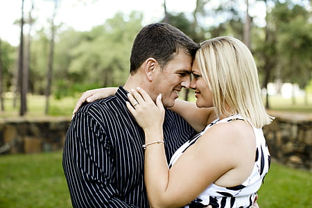 man holding women wearing white and black sleeveless shirt thumbnail