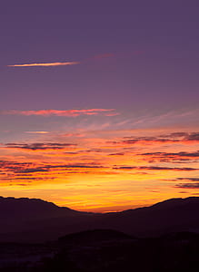 silhouette photography of mountain and clouds thumbnail