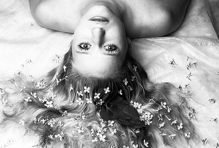 woman lying in white textile grayscale photo thumbnail