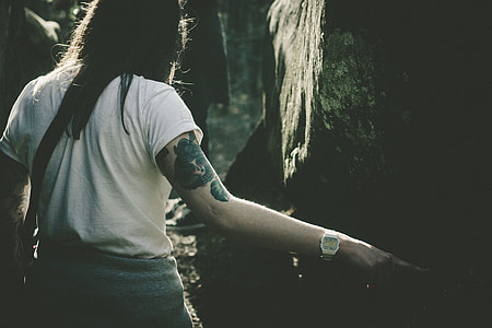 woman pointing tree in the forest during daytime thumbnail