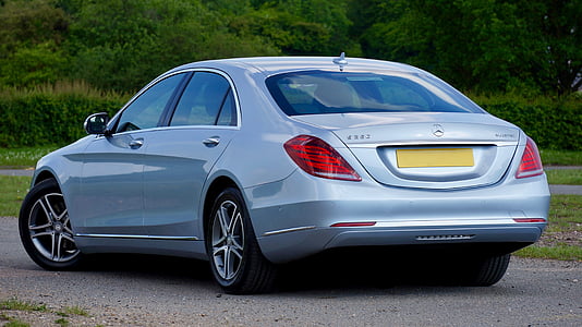 silver Mercedes-Benz sedan parked near green grass fiel;d thumbnail