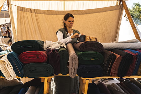 Woman Putting Bag Above Fabrics thumbnail