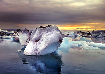 white ice berg on body of water during dawn thumbnail