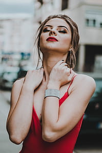 woman puts her hand on her neck thumbnail
