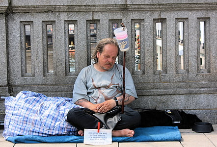 man sitting near concrete wall thumbnail