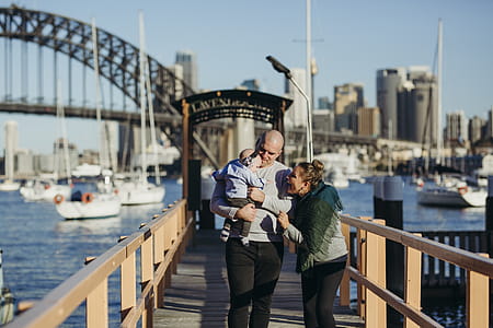 Male and Female With Baby Walking on Wooden Dock thumbnail