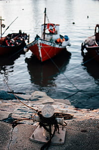 red boats near dock during daytime thumbnail