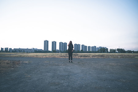 woman standing in front of building under clear blue sky during daytime thumbnail