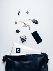 flat lay photography of devices and keys on white surface thumbnail