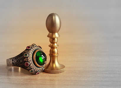 silver-colored ring with green gemstone thumbnail
