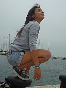 woman squatting on black post thumbnail