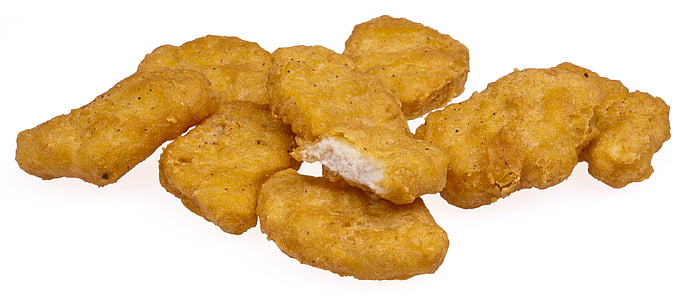 several chicken nuggets placed on white surface thumbnail