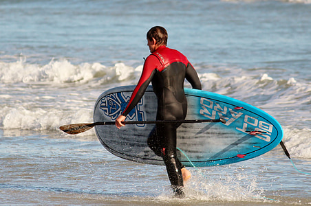 man carrying paddleboard thumbnail