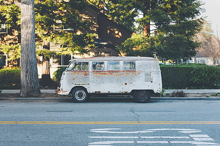 Volkswagen van on road beside tree thumbnail