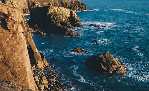 brown rock formation and ocean thumbnail