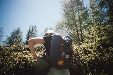 person opening his bag while standing near pklant thumbnail