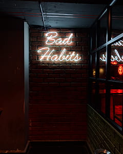 bad habits neon signage thumbnail