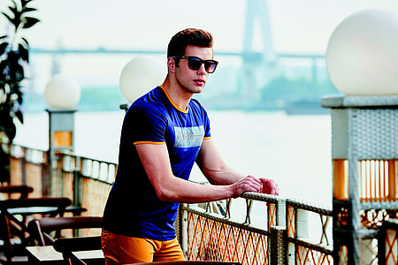 man in blue crew-neck shirt watching river view during daytime thumbnail